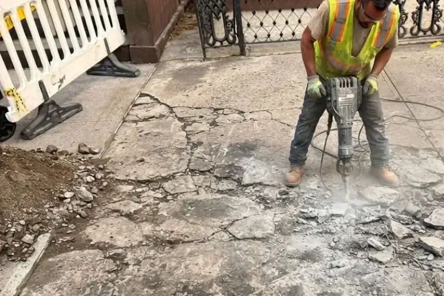 Damaged Brooklyn sidewalk concrete being removed for violation repair